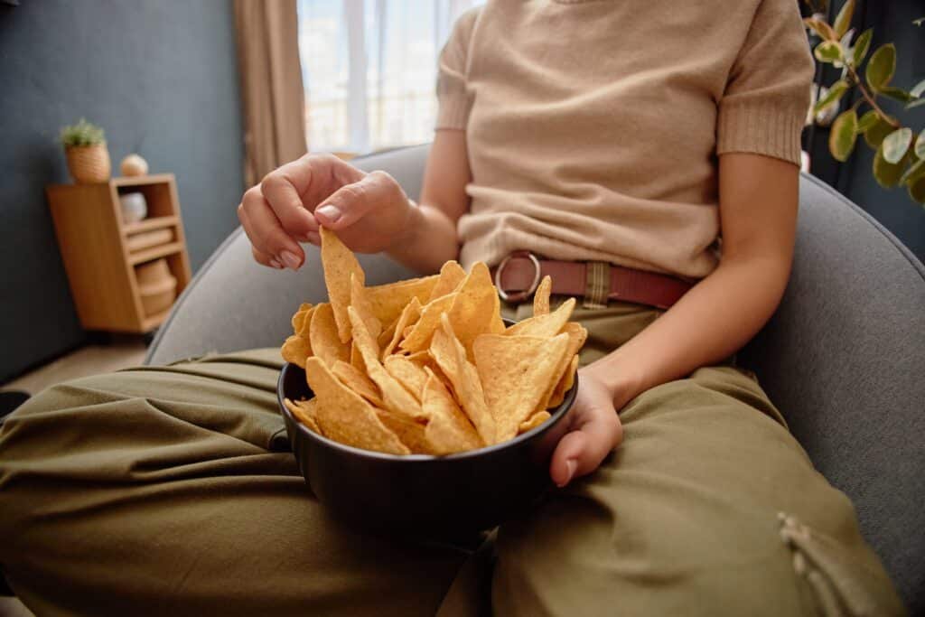 woman eating snacks while sitting