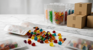 colorful gummy candies spilling from several unbranded matte stand-up pouches