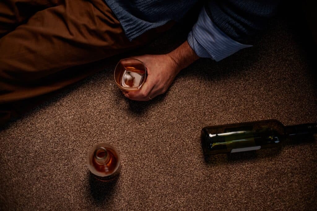 man sitting after taking delta-8 gummies with alcohol