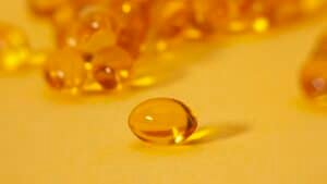 Golden CBD capsules in soft close-up