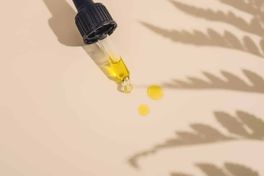 Dropper bottle of hemp extract with a label showing its terpene profile