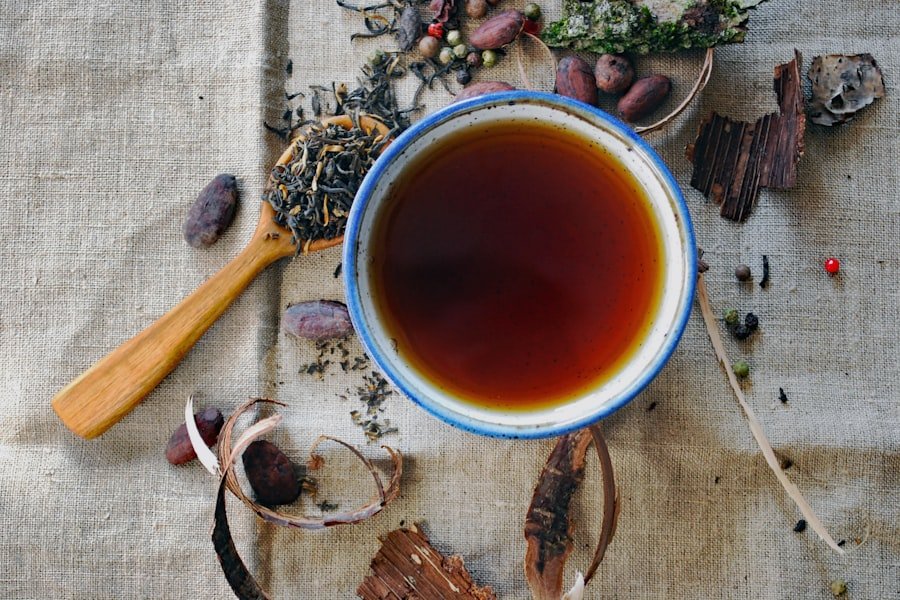 Cup of herbal tea beside loose botanicals, a calm moment for a CBD tincture routine