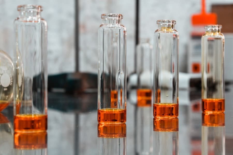 Glass vials of amber CBD distillate lined up after filtering