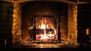 A wood fire burning in a stone fireplace on a quiet evening