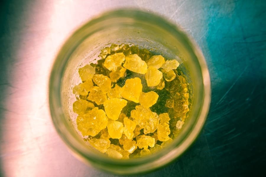 Golden concentrate viewed from above inside a glass jar