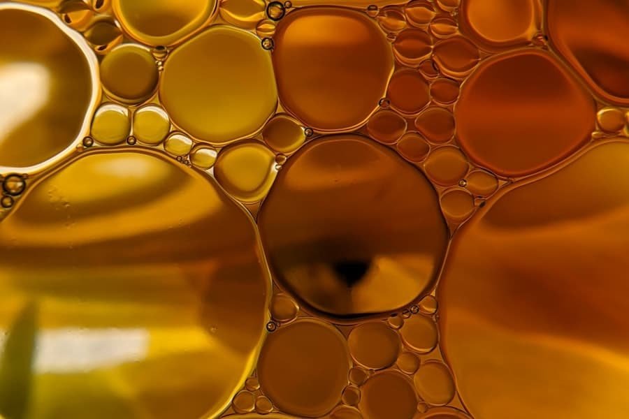 Macro view of golden oil bubbles suspended in liquid