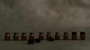 A row of small unlabeled amber glass bottles