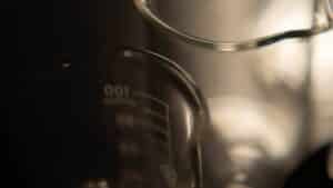 Laboratory beakers photographed in low warm light