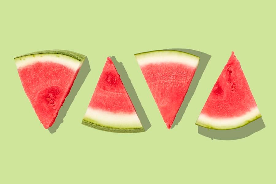 Slices of watermelon arranged on a green background