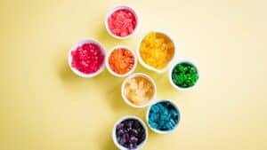 Coloured gummies sorted into small white bowls