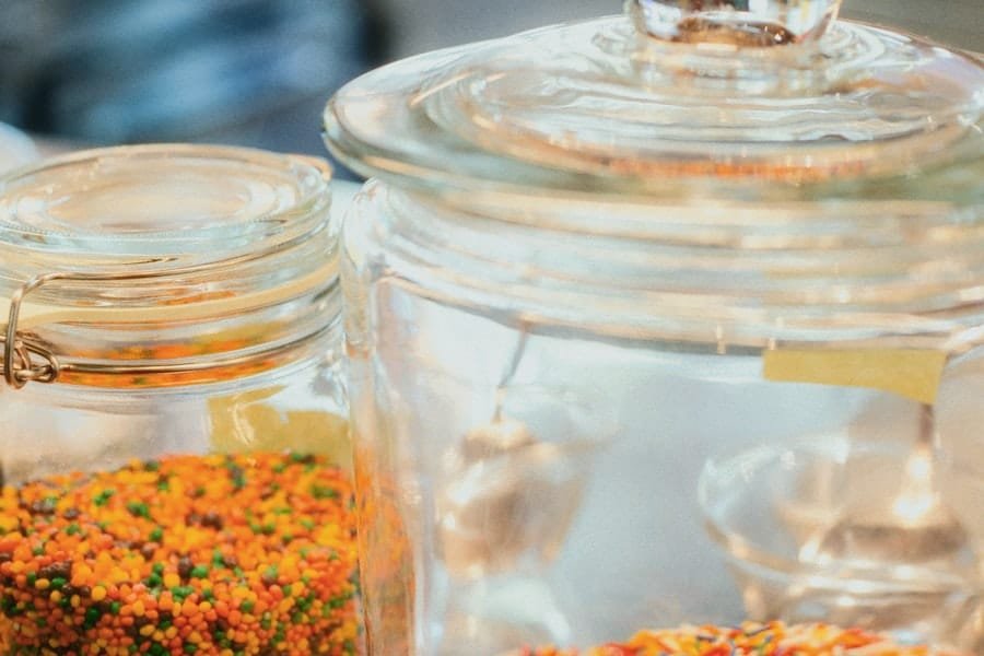 Glass jars of coloured sprinkles on a tray