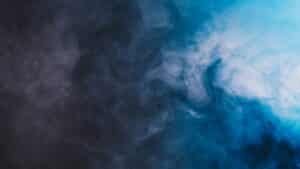 Pale vapour drifting against a dark background