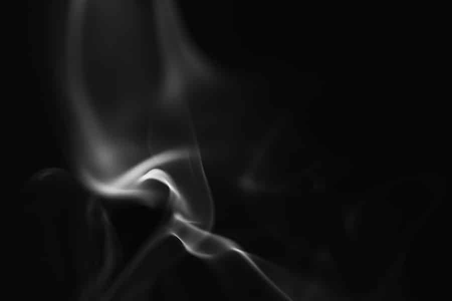 A thin wisp of vapour against a black background