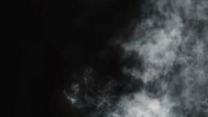 Soft vapour curling against a black background