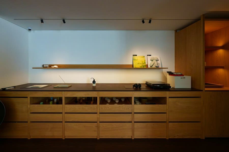A long run of wooden cabinets and drawers in a softly lit room