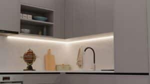 A kitchen corner with tall closed cabinets and a high open shelf