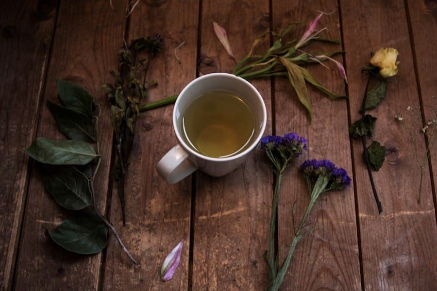 A mug of herbal tea on a wooden table surrounded by dried flowers
